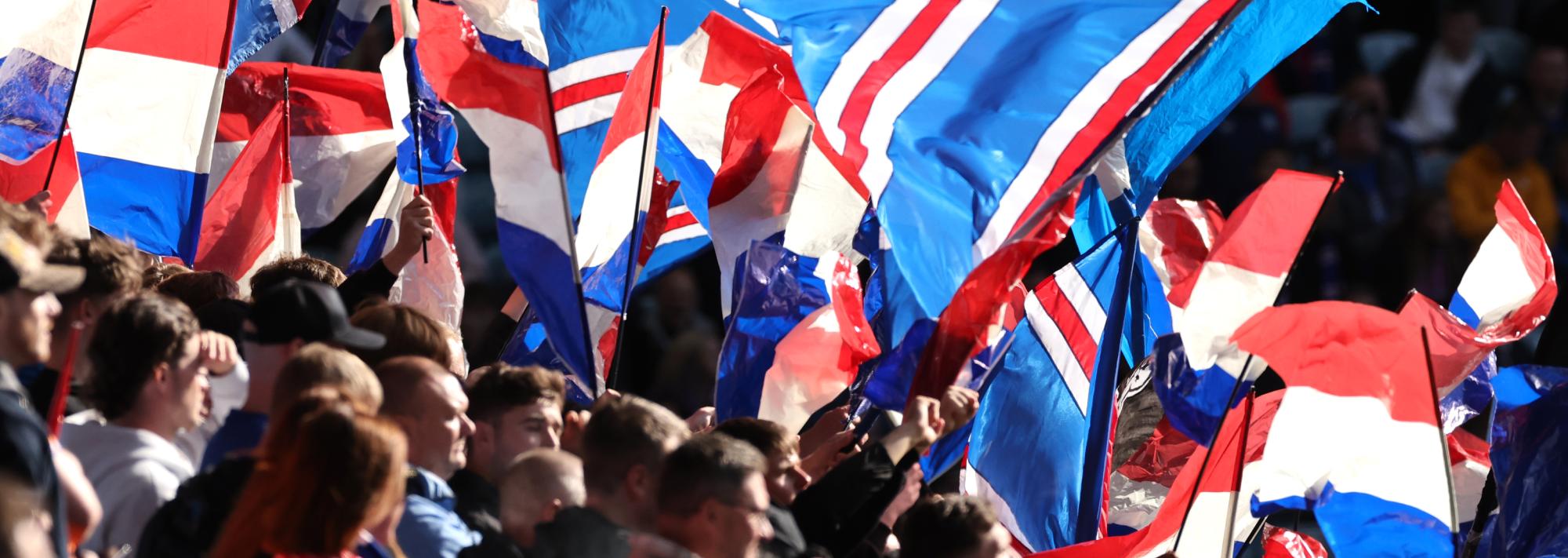 Fans waving Icelandic flags at a sports event
