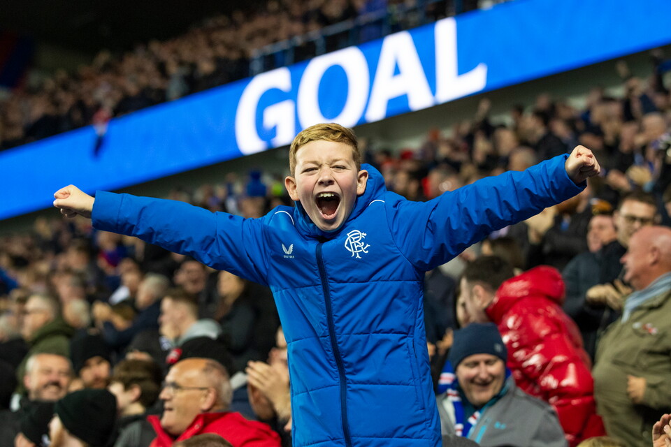 Rangers fan celebrating a goal at Ibrox.
