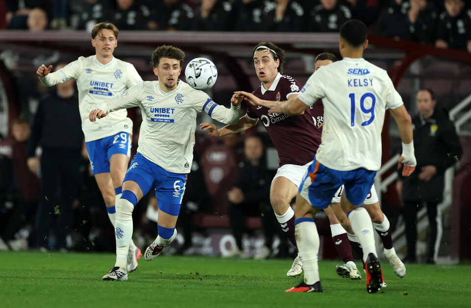 Football players in action with one player about to kick a ball.