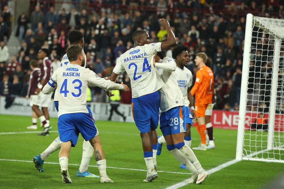 Players celebrating a goal with number 24 lifting his hands high