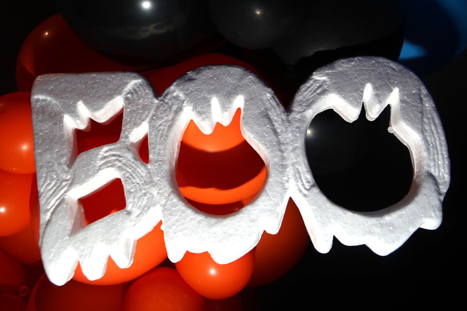 White plastic teeth with orange centres sit atop orange balloon array.