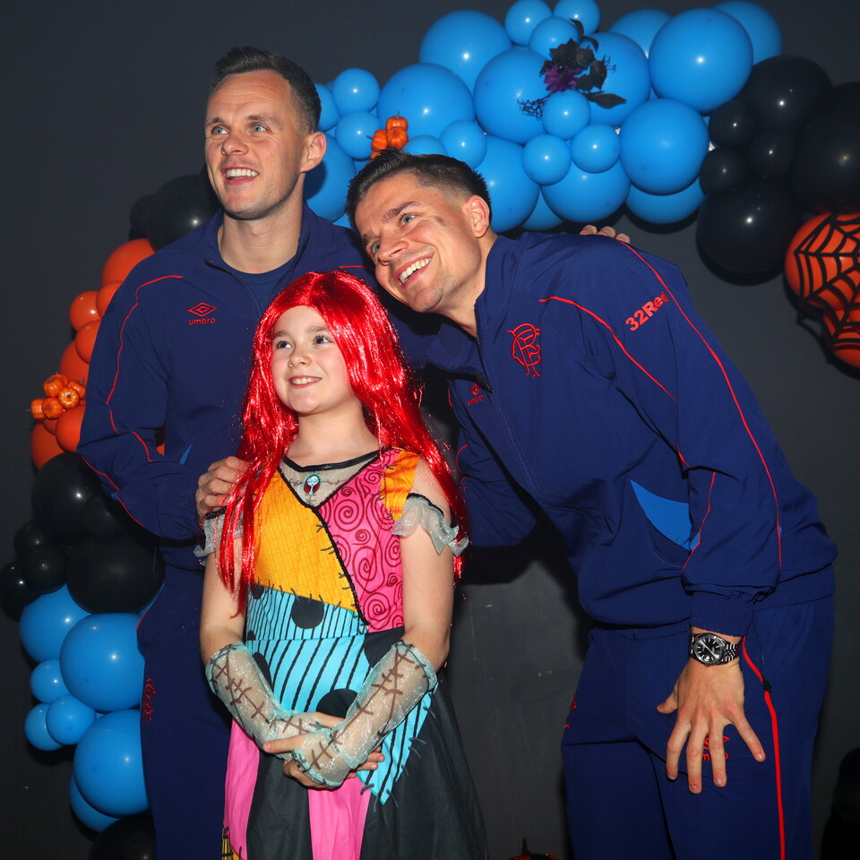 Three Manchester United players pose with a child dressed as a character from a film