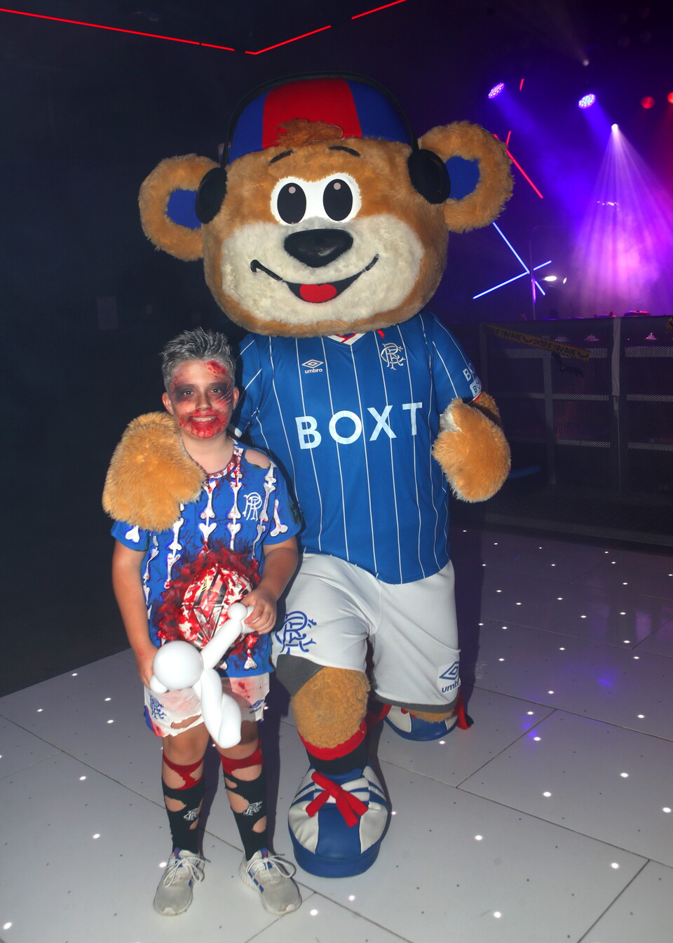 Mascot wearing blue and white shirt with "BOXT" text and a child in red face paint