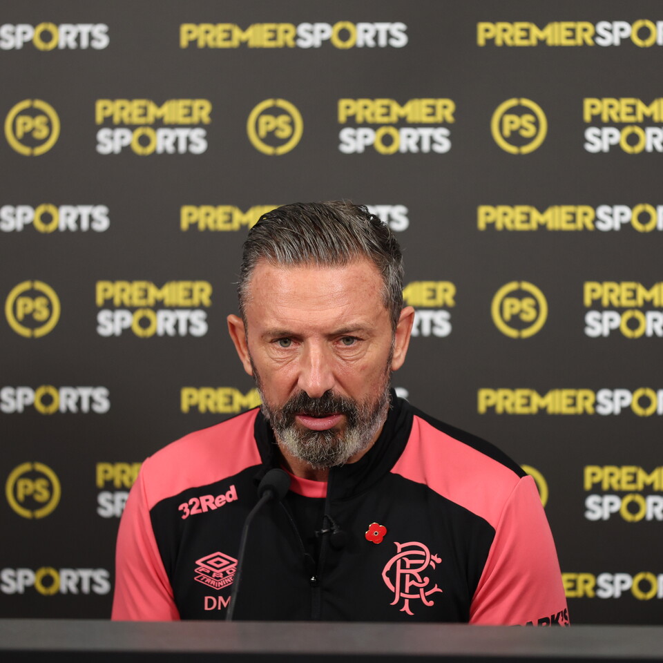 Coach of a football team speaking at a press conference.