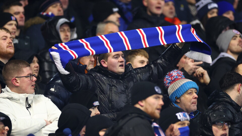 Fan in crowd with Rangers scarf 