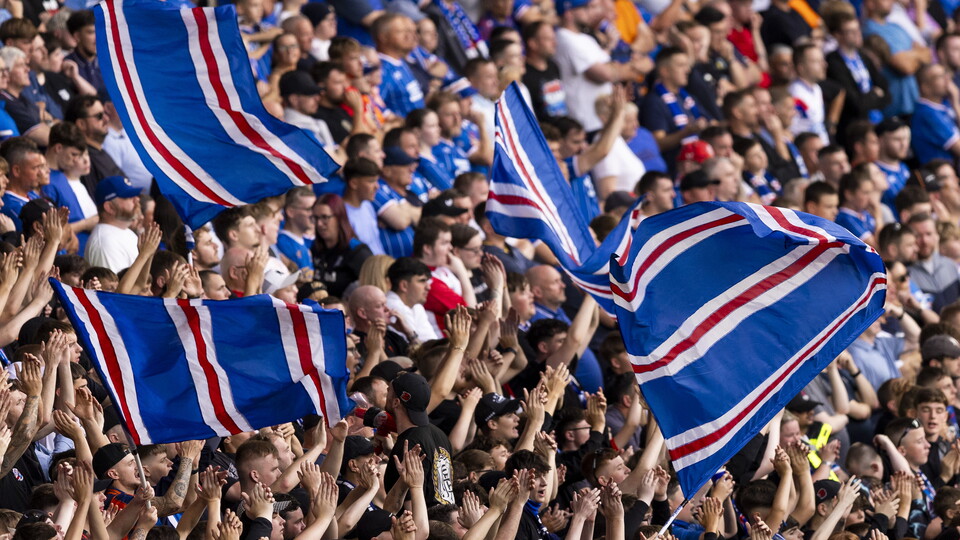 Fans waving Iceland flags at a football stadium