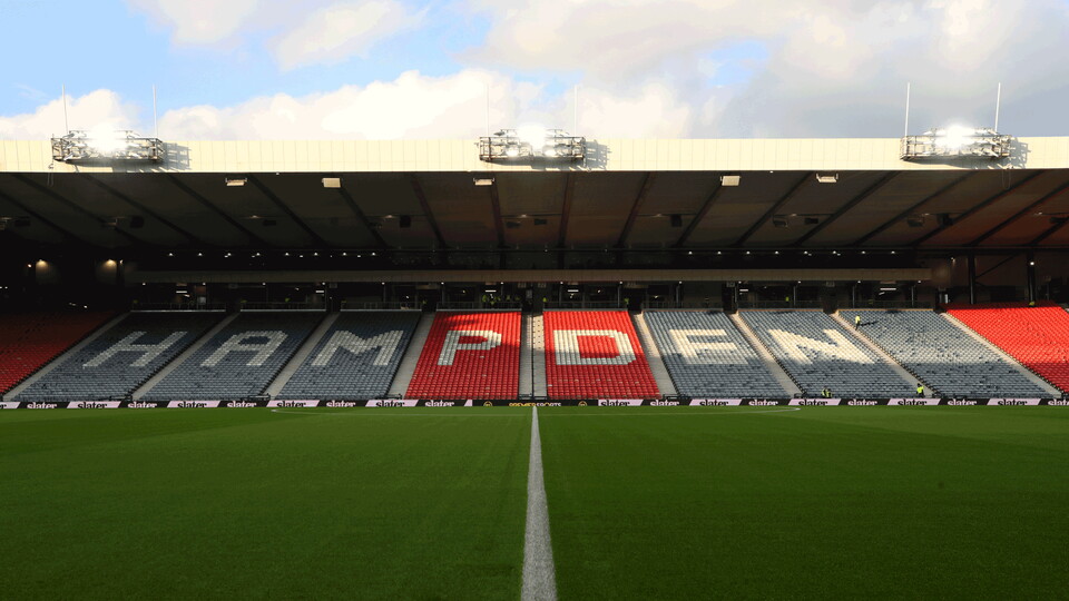 Empty Hampden Park stadium with the word Hampden spelled out in red across the stands